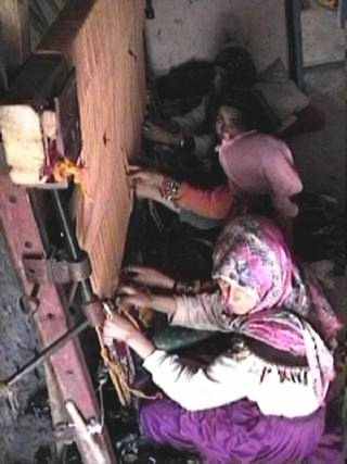 Taliouine women working on a rug